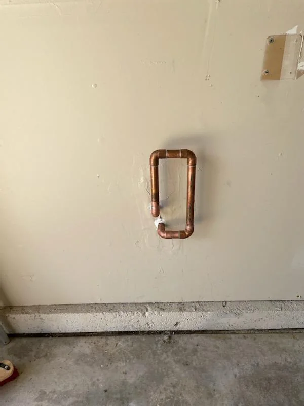 Copper pipe loop and fittings at an interior wall